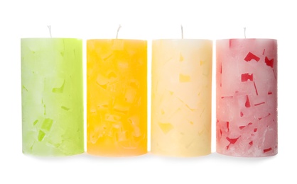 Four color wax candles on white background