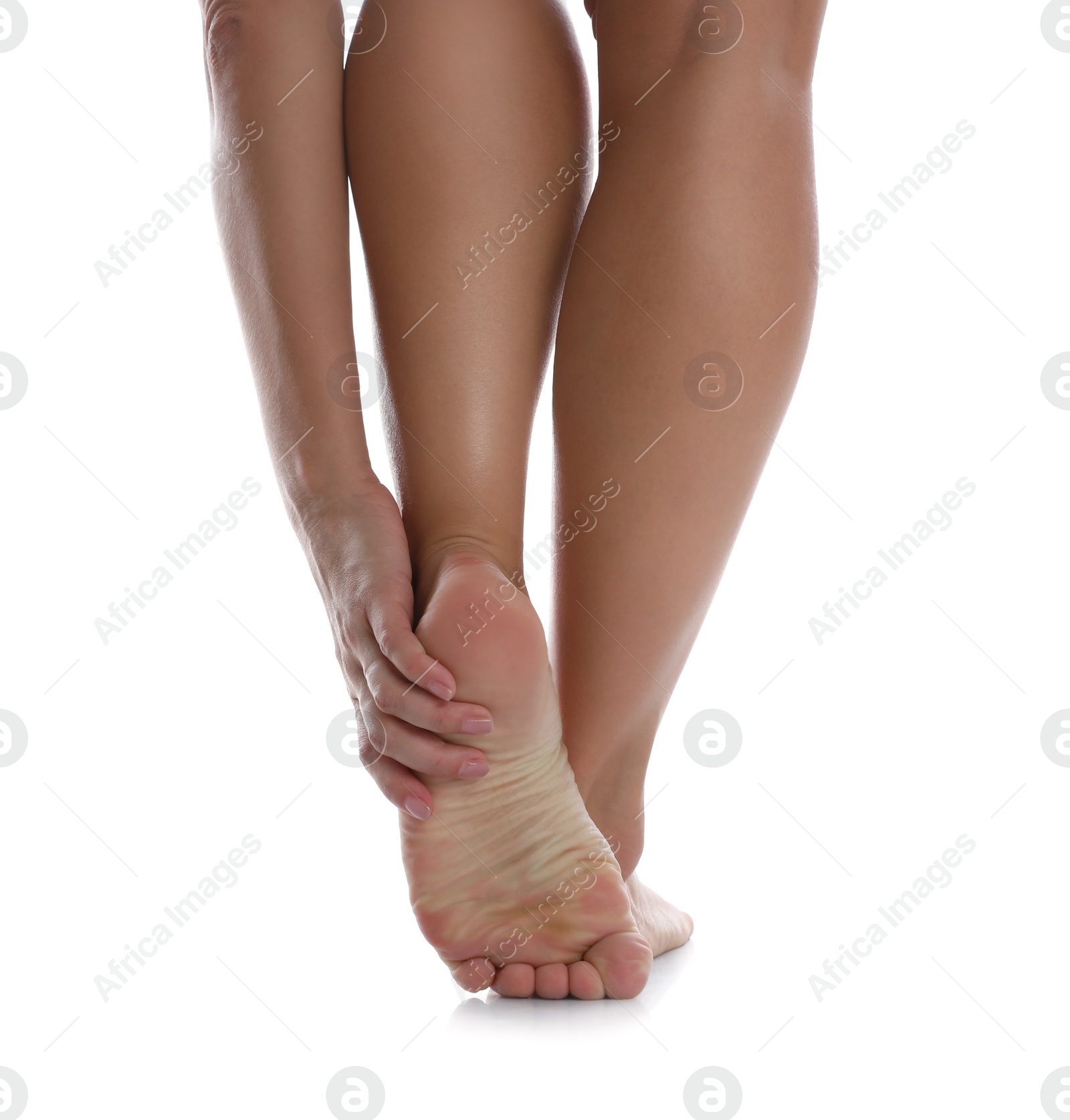 Photo of Back view of woman suffering from foot pain on white background, closeup