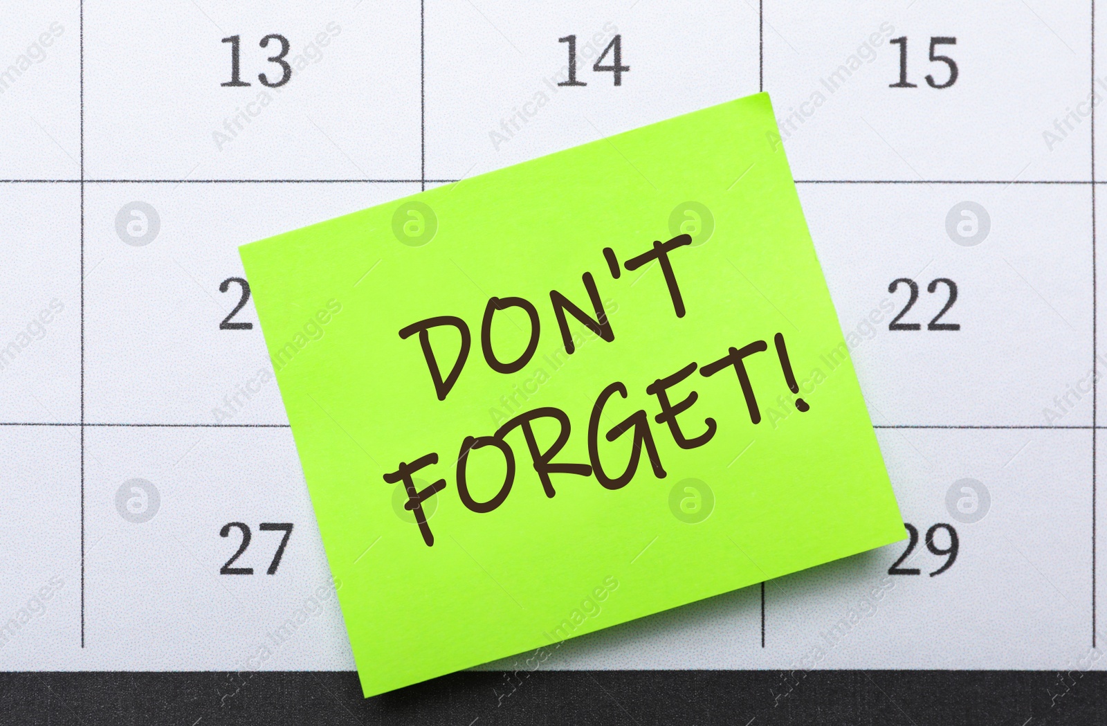 Image of Reminder note with text DON'T FORGET on calendar, top view