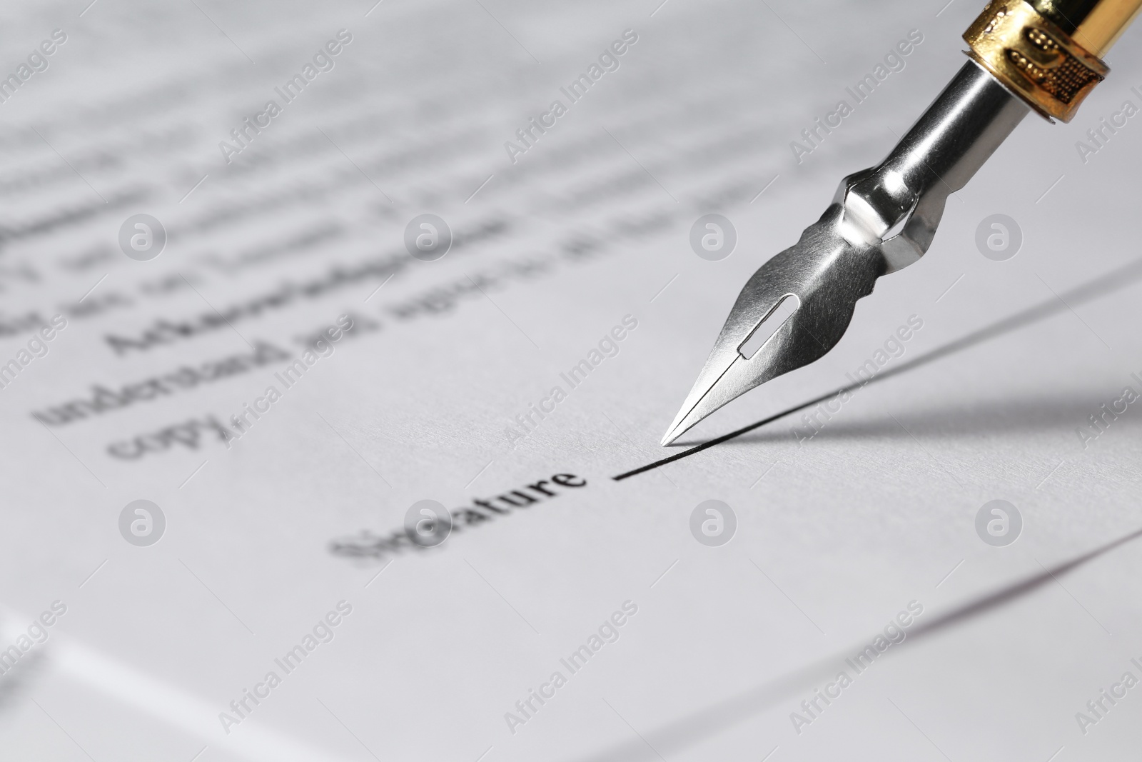 Photo of Signing notary document with fountain pen, closeup