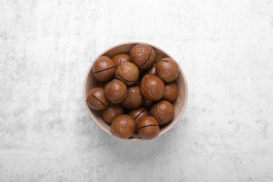 Delicious organic Macadamia nuts on light gray table, top view