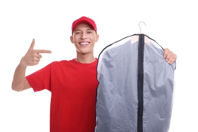 Photo of Dry-cleaning delivery. Happy courier holding garment cover with clothes on white background