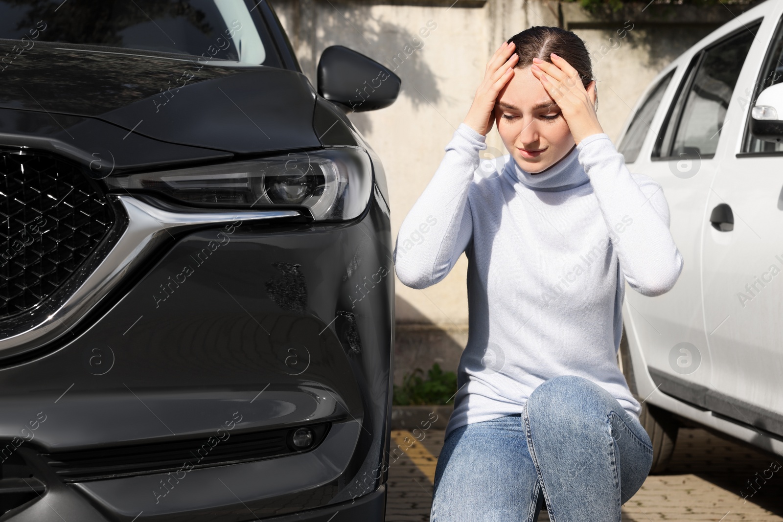 Photo of Stressed woman near car with scratch outdoors