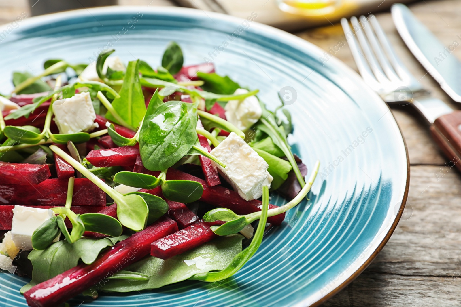 Photo of Plate with delicious beet salad on table, closeup