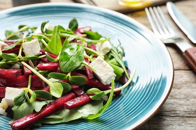 Plate with delicious beet salad on table, closeup