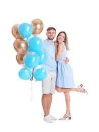 Young couple with air balloons on white background