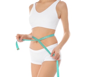 Photo of Slim woman measuring her waist on white background, closeup. Weight loss