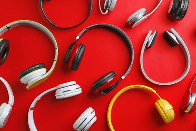 Photo of Many different headphones on color background, top view