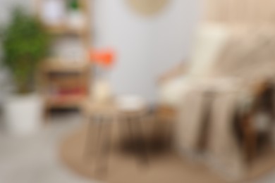 Blurred view of stylish room, plant and furniture