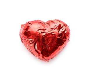 Photo of Heart shaped chocolate candy in red foil on white background, top view