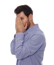 Photo of Embarrassed man covering face with hands on white background