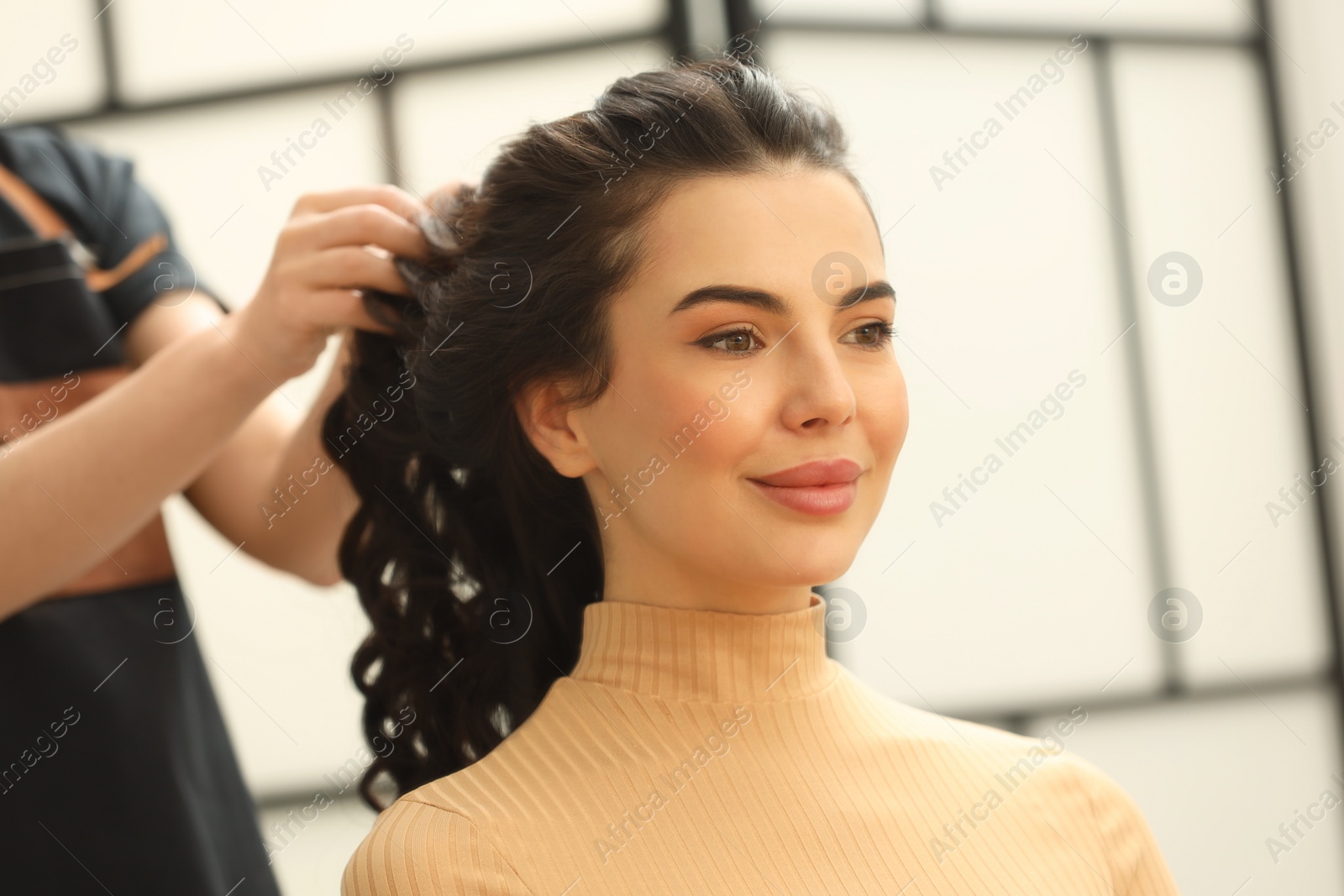 Photo of Hair styling. Professional hairdresser working with client indoors, closeup