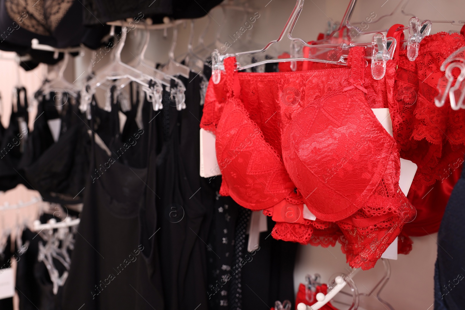 Photo of Many different beautiful women's underwear in lingerie store, closeup