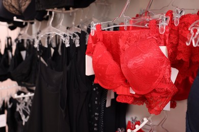 Photo of Many different beautiful women's underwear in lingerie store, closeup