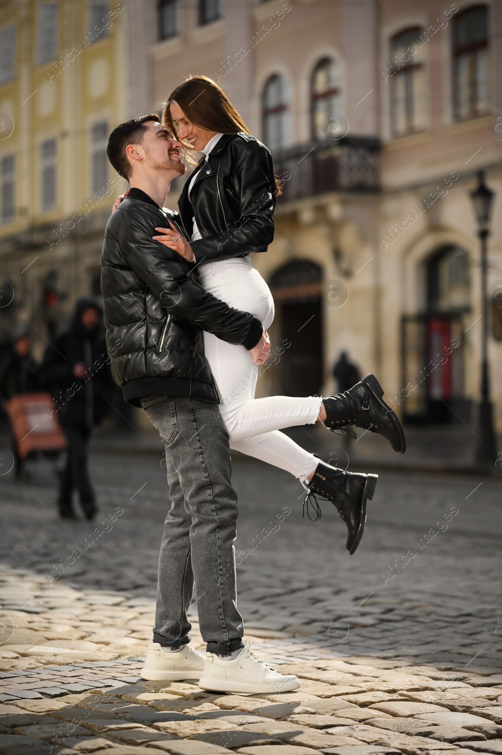 Photo of Lovely young couple having fun together on city street. Romantic date