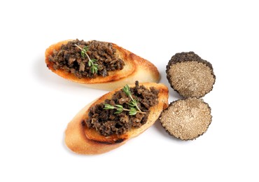 Tasty bruschettas with truffle paste on white background, top view
