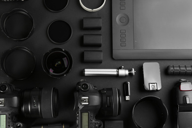 Photo of Flat lay composition with equipment for professional photographer on black background