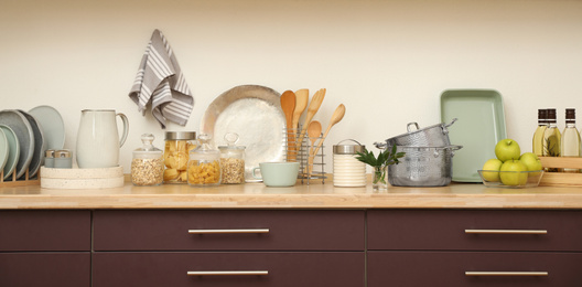 Photo of Stylish kitchen interior with wooden countertop and wall cabinets