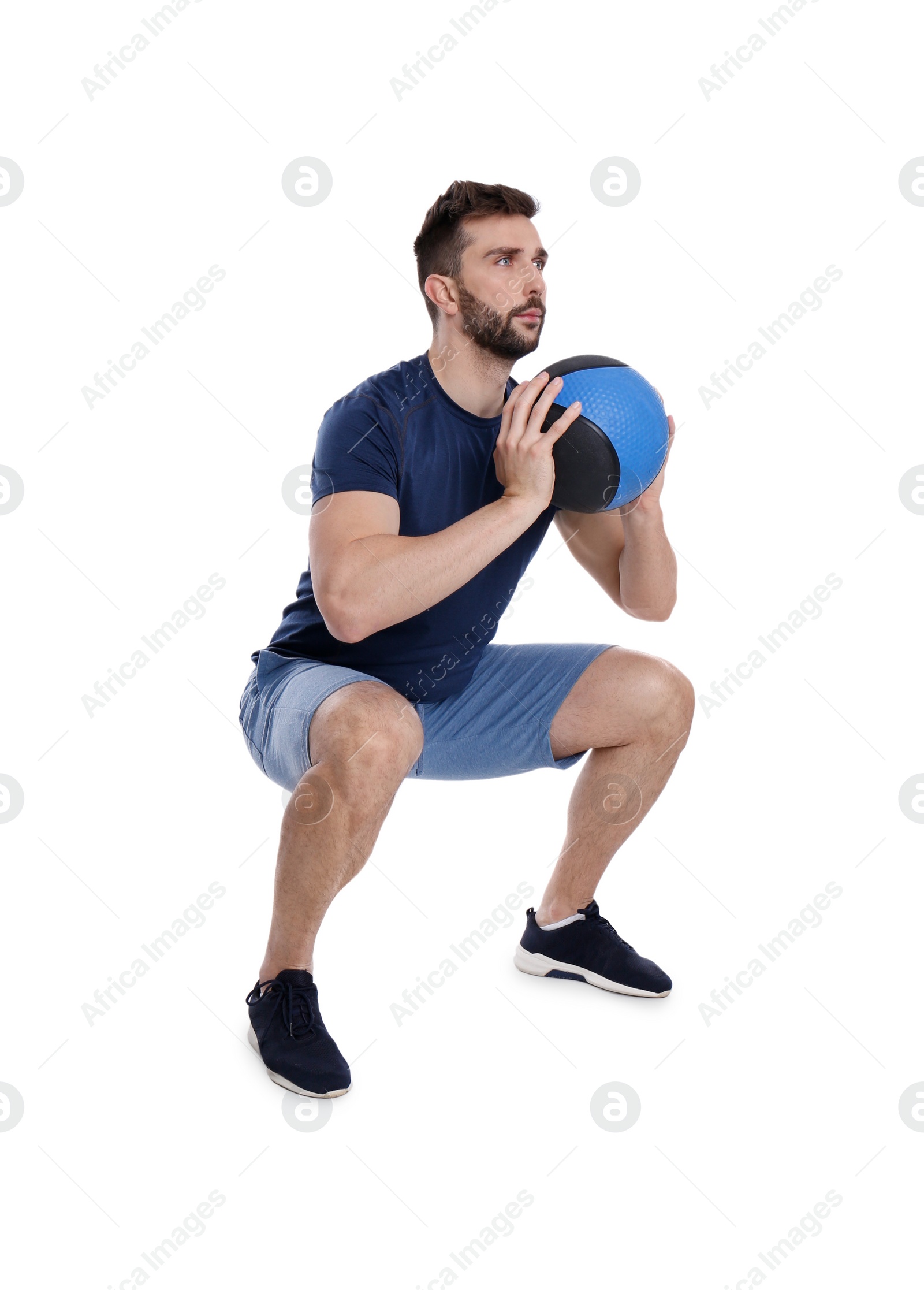 Photo of Athletic man doing squats with medicine ball isolated on white