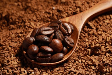 Photo of Spoon with roasted beans on instant coffee, closeup
