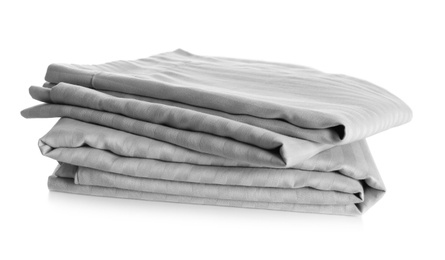 Photo of Stack of clean bed sheets isolated on white