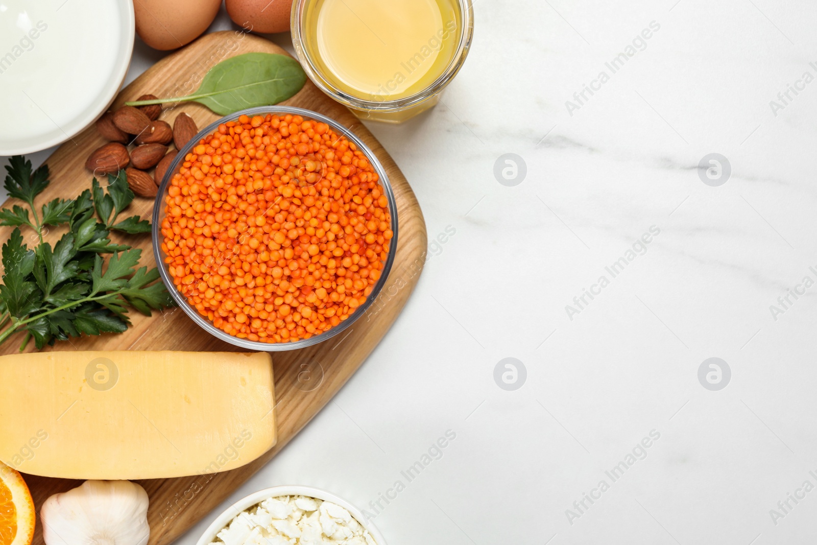 Photo of Set of natural food high in calcium on white marble table, flat lay. Space for text