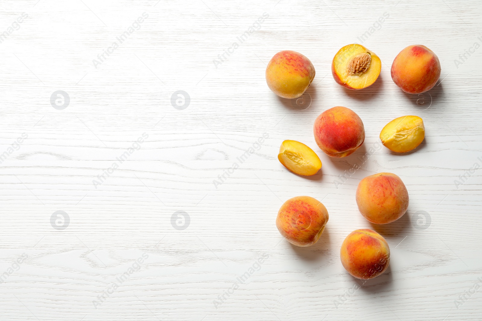 Photo of Fresh sweet peaches on wooden table, top view