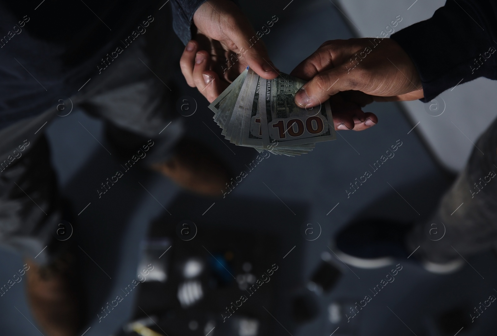 Photo of Addicted man buying drugs from dealer on blurred background, closeup