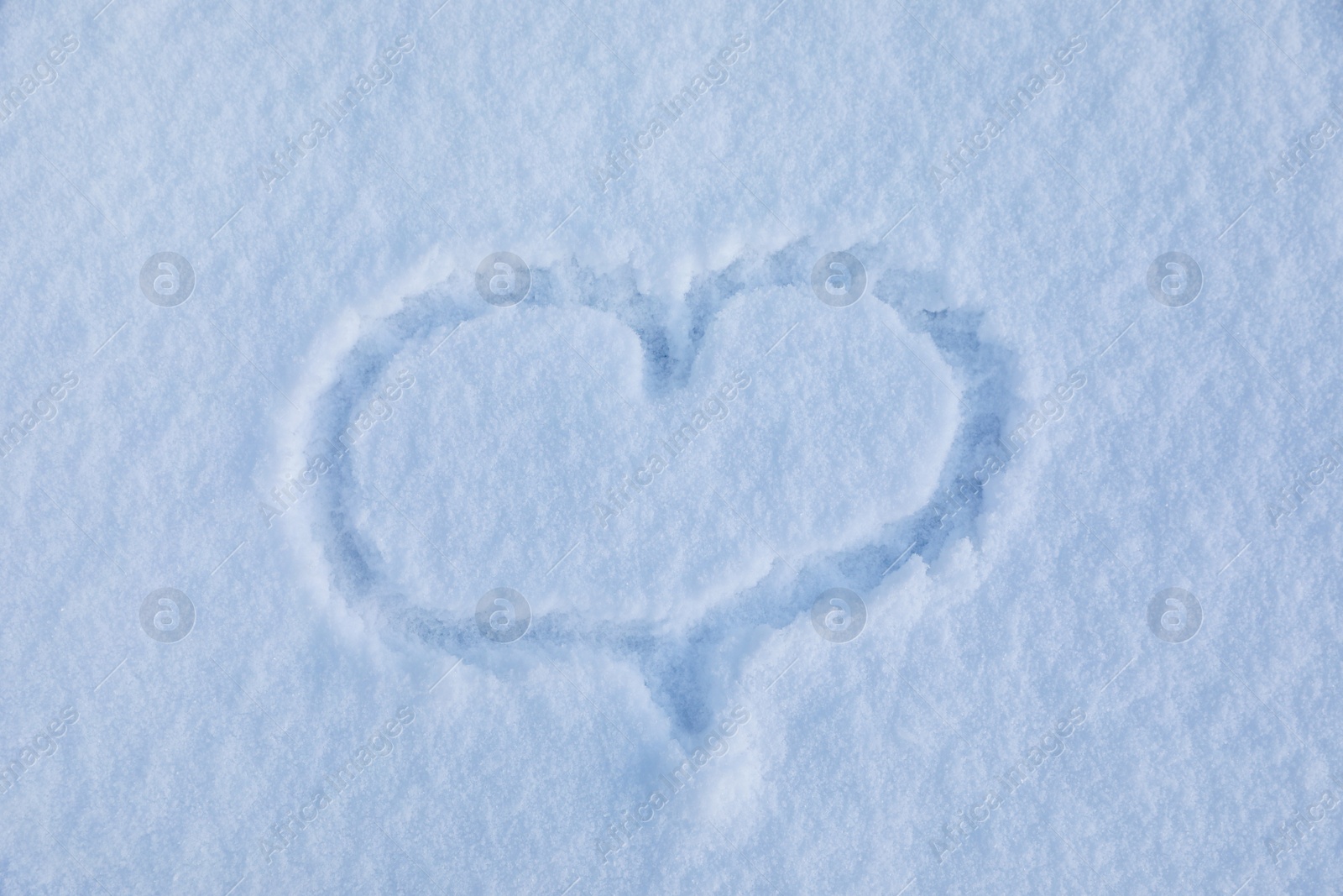 Photo of Heart drawn on snow, top view. Winter season