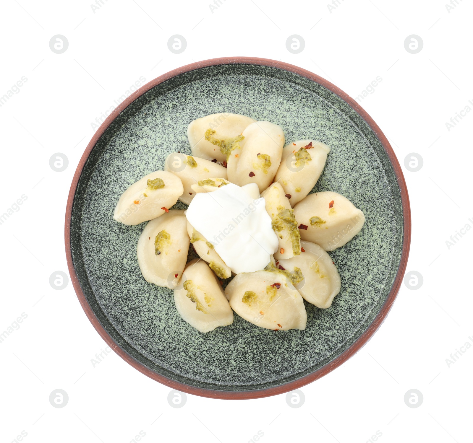 Photo of Delicious cooked dumplings with sour cream on white background, top view