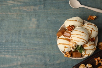 Photo of Flat lay composition with delicious ice cream on wooden table. Space for text
