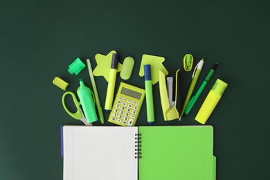 Photo of Flat lay composition with different school stationery on green chalkboard. Back to school