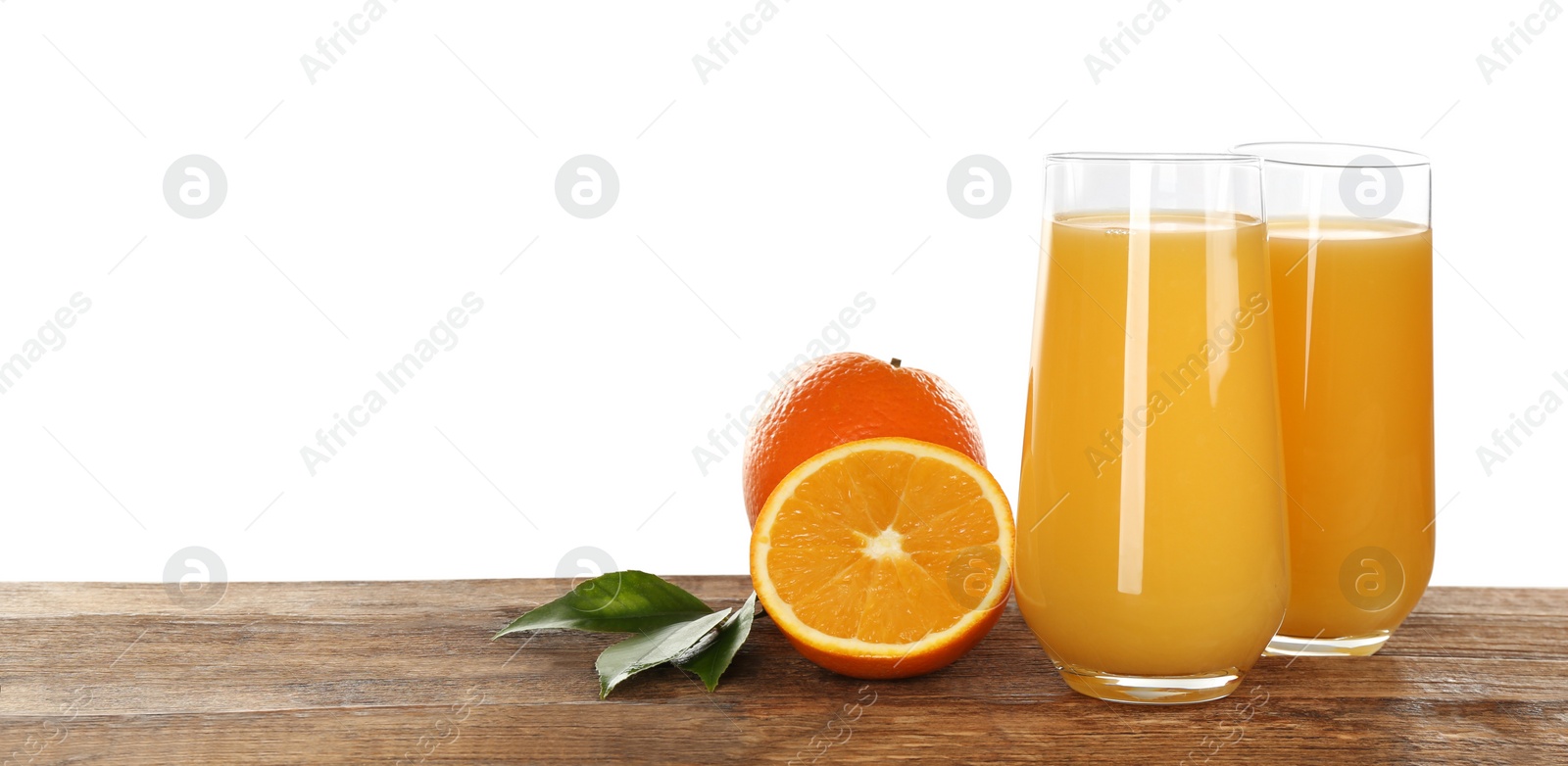 Photo of Delicious orange juice and fresh fruits on wooden table against white background