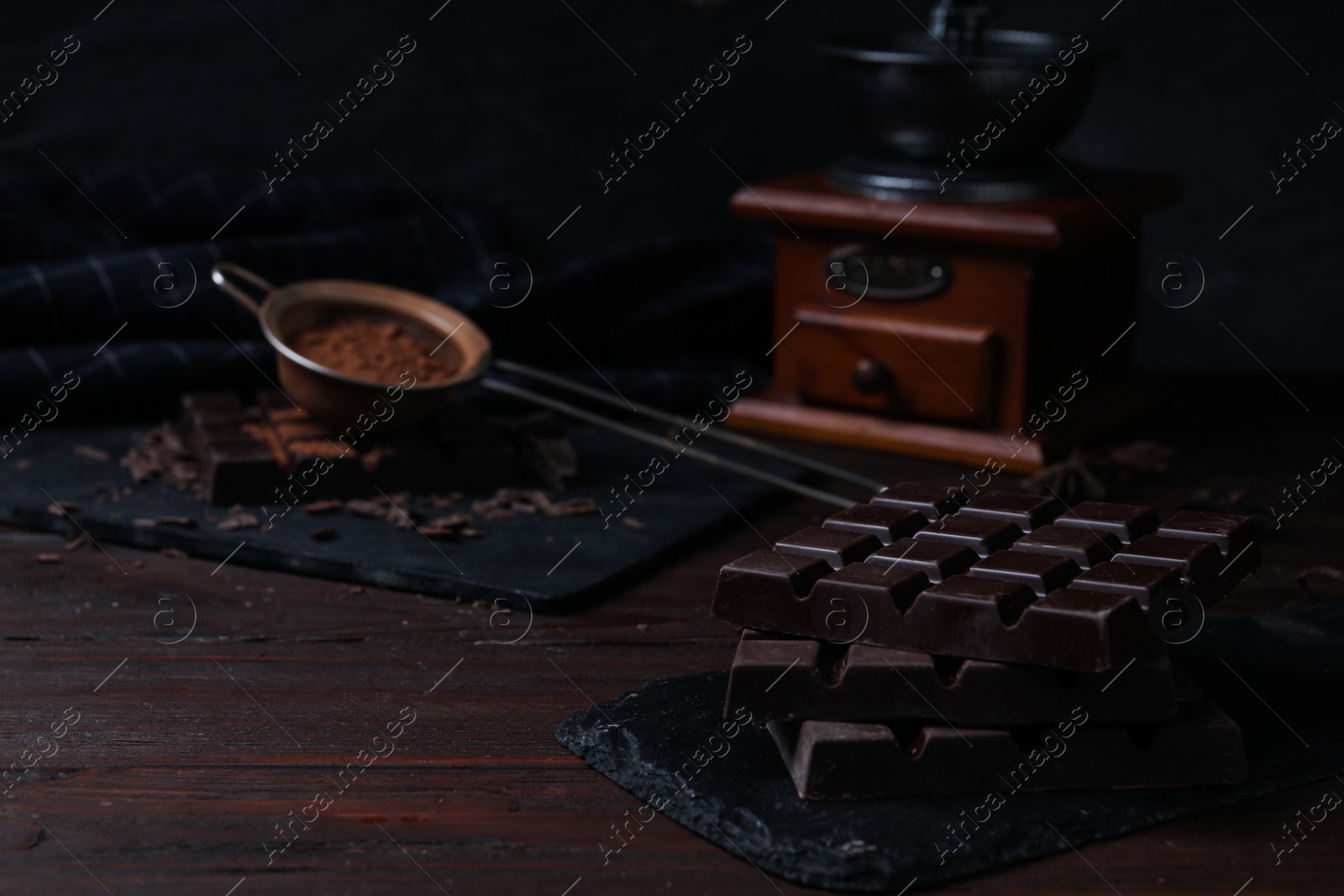 Photo of Tasty dark chocolate bars on wooden table