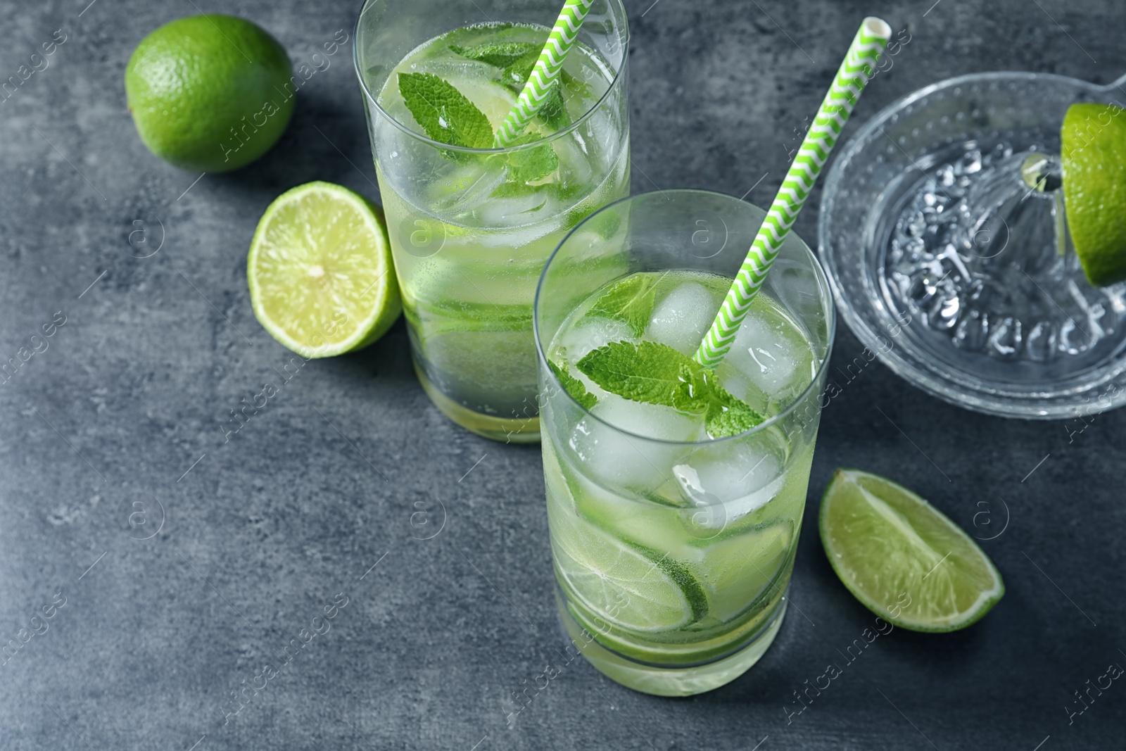 Photo of Glasses of natural lemonade with lime on table