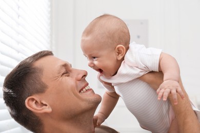 Happy father with his little baby at home