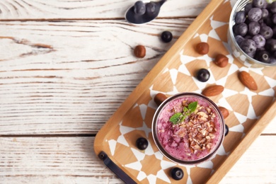 Photo of Flat lay composition with glass of delicious acai juice on wooden table