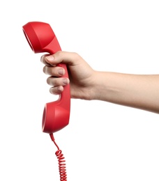Photo of Woman holding red corded telephone handset on white background, closeup. Hotline concept