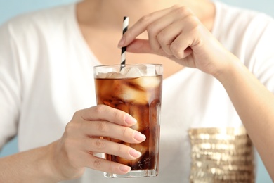 Photo of Woman with glass of tasty refreshing cola, closeup view