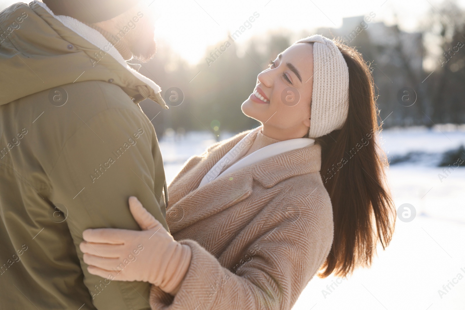 Photo of Beautiful happy couple in snowy park on winter day