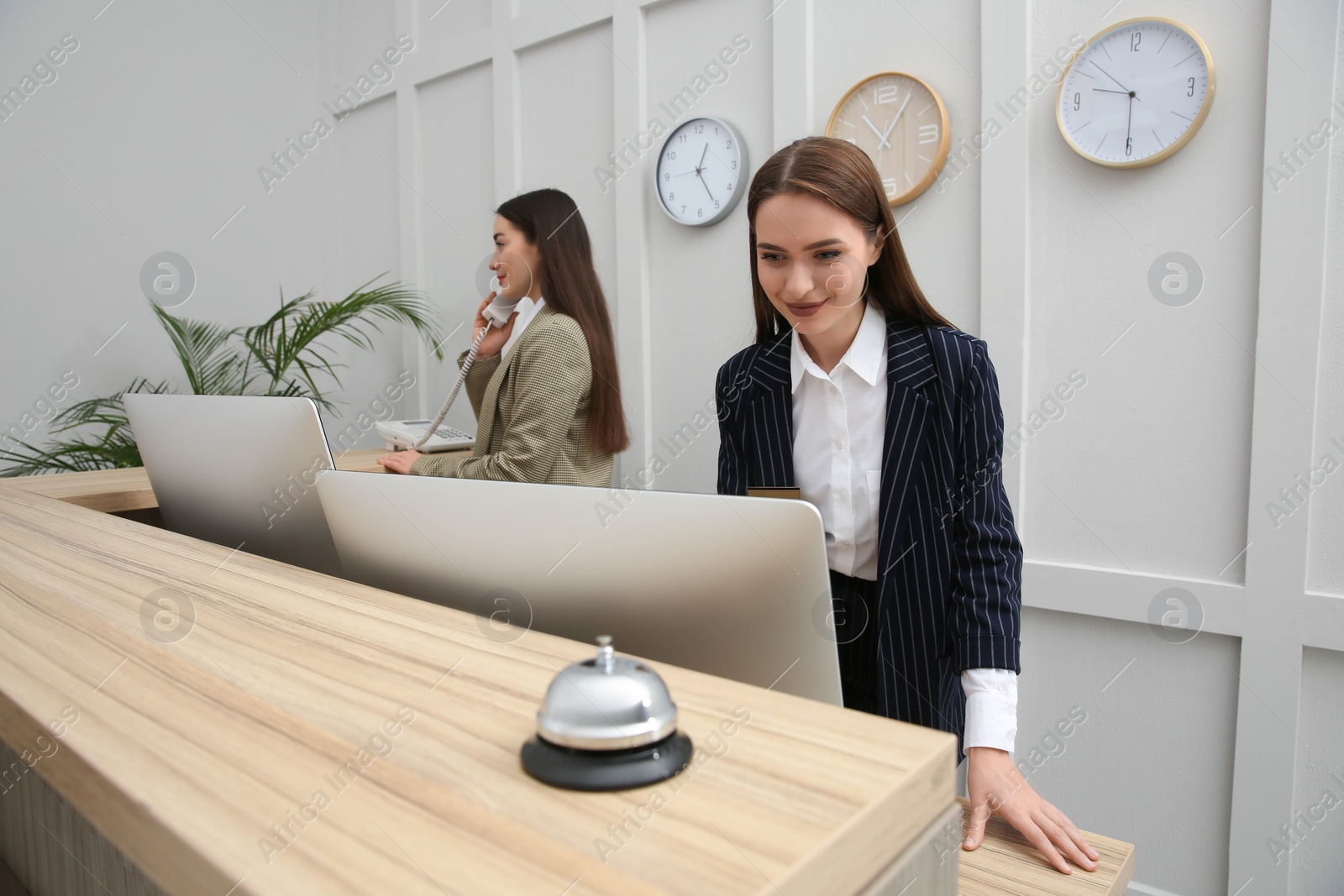 Photo of Beautiful receptionists working at counter in hotel