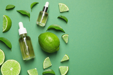 Flat lay composition with lime essential oil on green background