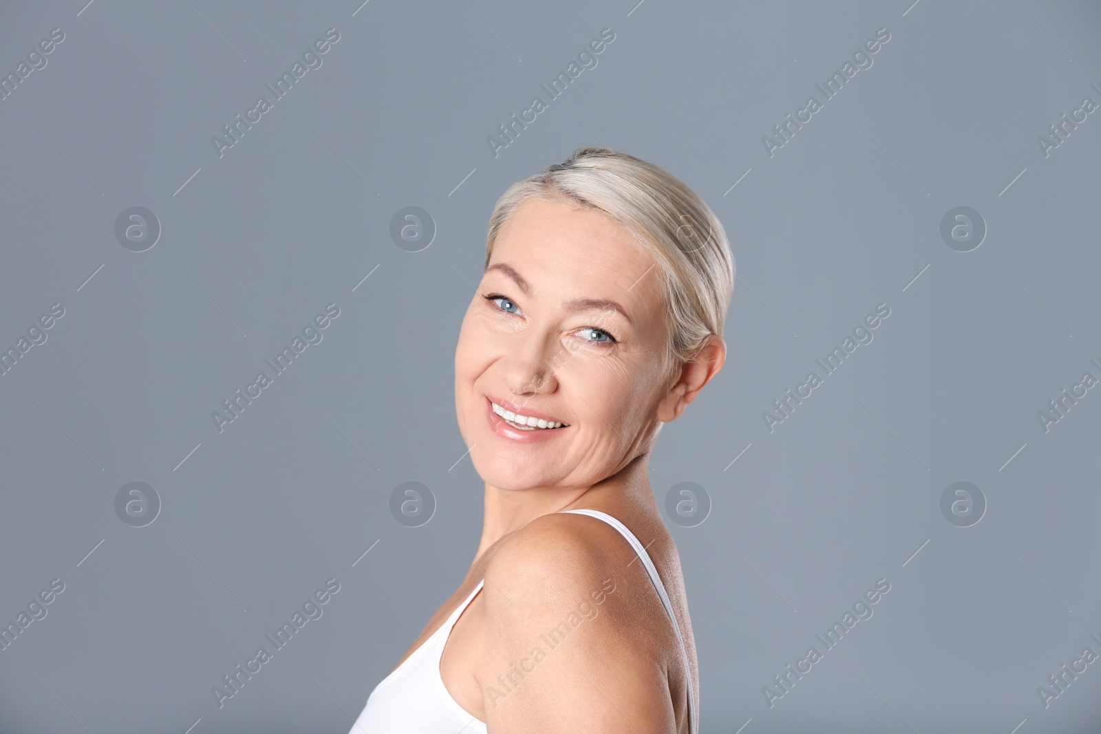 Photo of Portrait of beautiful mature woman on grey background