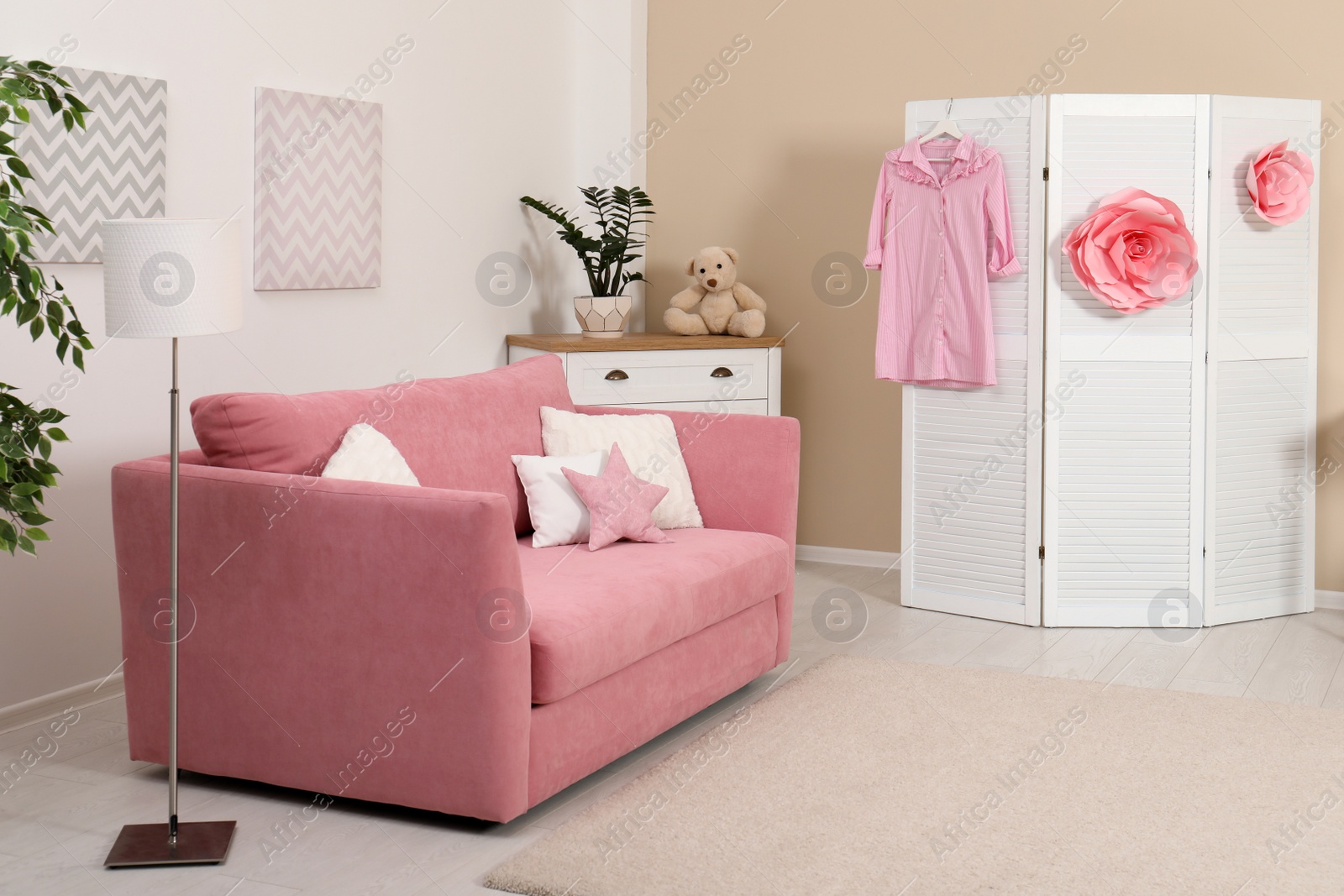 Photo of Cozy child room interior with sofa and modern decor elements