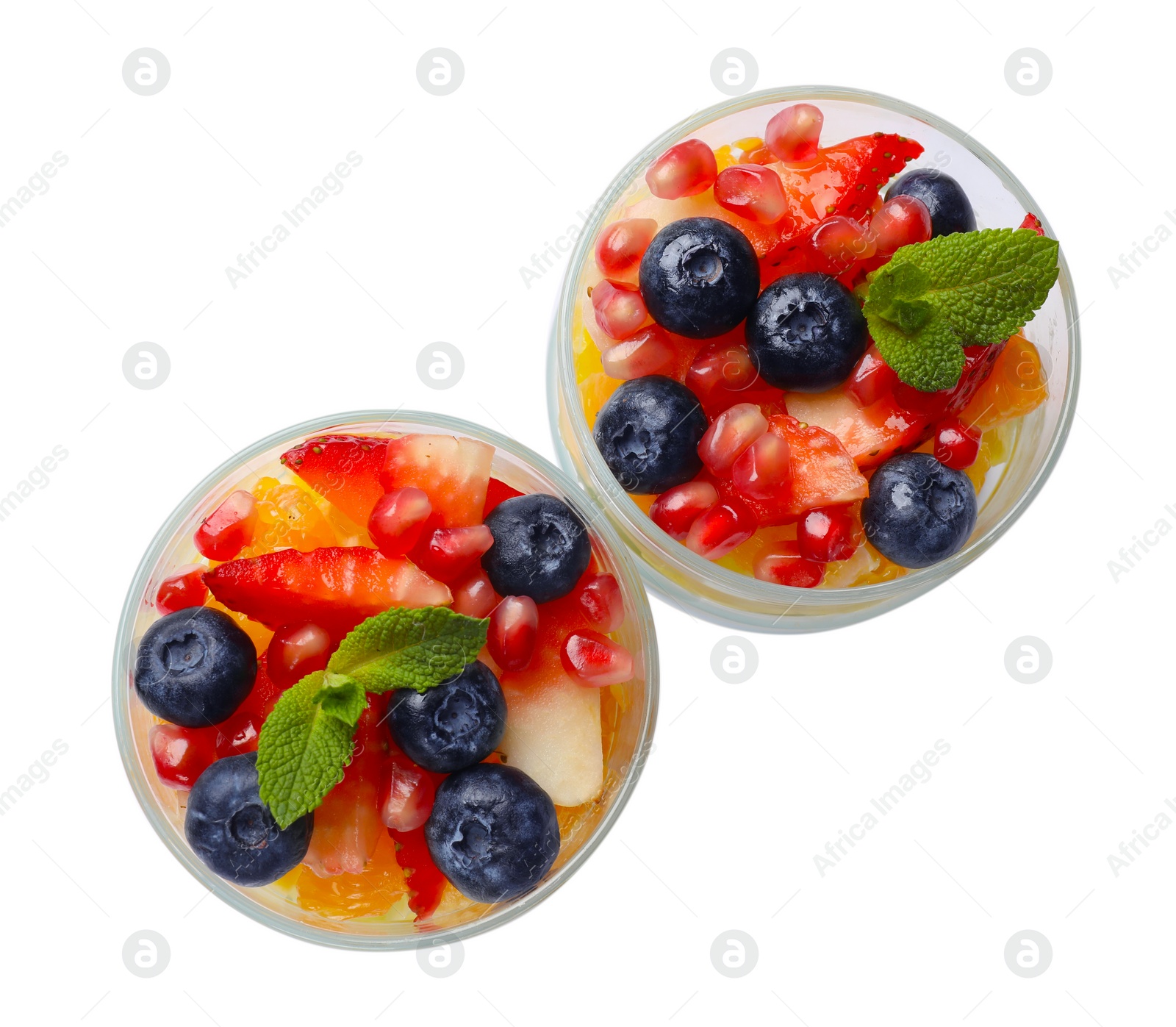 Photo of Delicious fruit salad in glasses isolated on white, top view