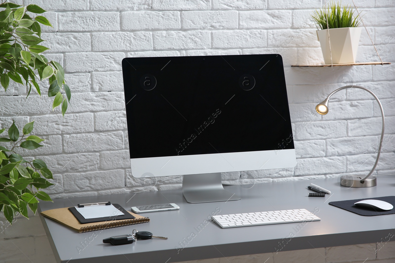 Photo of Interior of comfortable work place with computer on table at home