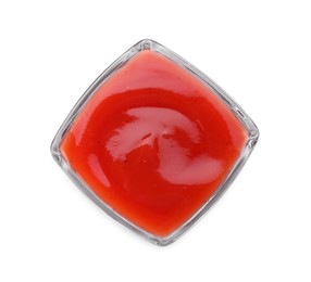 Photo of Glass bowl of tasty ketchup isolated on white, top view. Tomato sauce