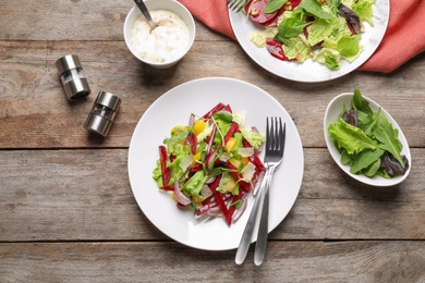 Delicious beet salad on wooden table, top view