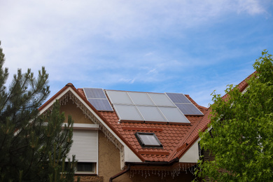 House with installed solar panels on roof