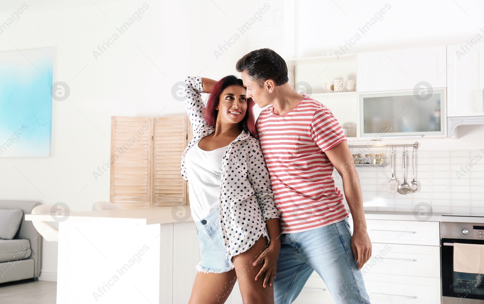 Photo of Beautiful couple dancing in kitchen at home